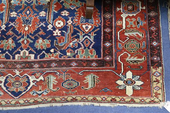 A Kazak style blue ground rug, woven with stylised flowerheads, 224cm x 135cm